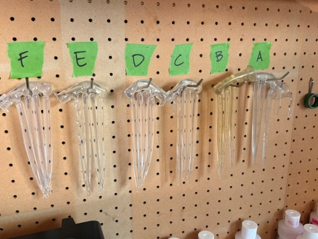 MAT-001 side-by-side comparison of Brands A through F clear soft-plastic baits